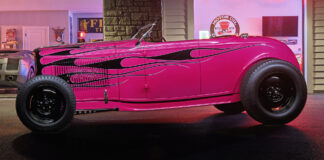 01 Hot pink 1932 Ford Roadster with black flame graphics steel wheels and a vintage custom stance