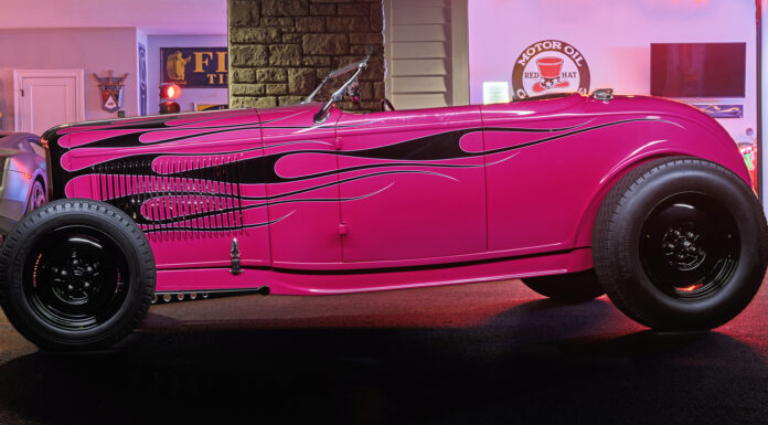 01 Hot pink 1932 Ford Roadster with black flame graphics steel wheels and a vintage custom stance