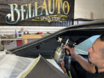 01 Upholstery shop worker spraying adhesive for a 1970 Chevy Nova headliner installation