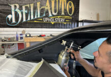 01 Upholstery shop worker spraying adhesive for a 1970 Chevy Nova headliner installation