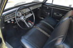 010 1967 Chevrolet Nova interior shot with black bench seats and chrome accented steering wheel for vintage appeal