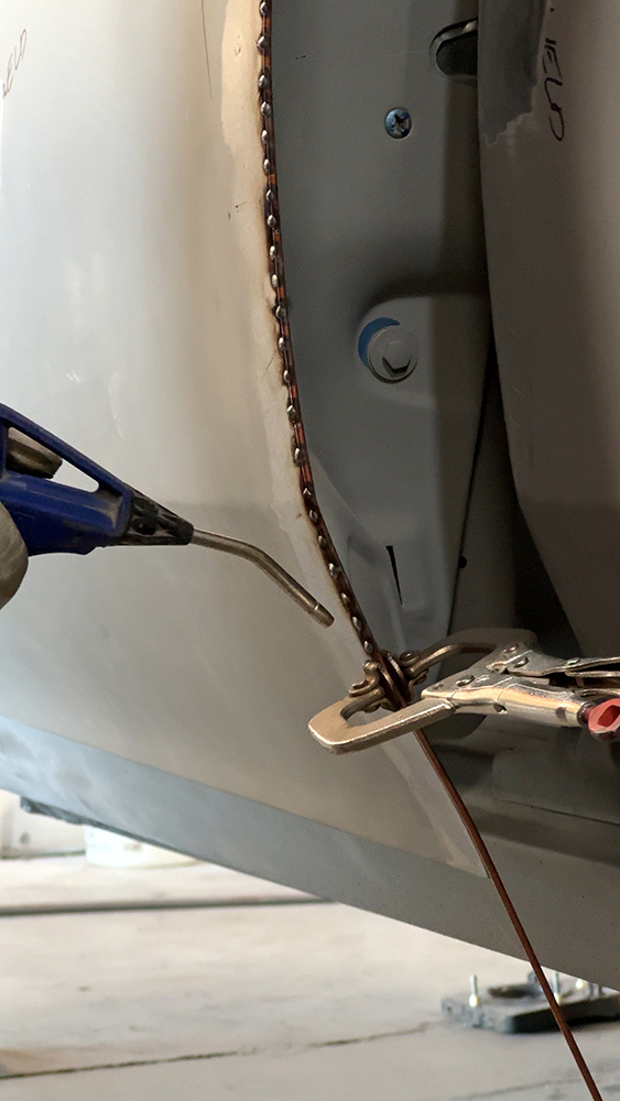 011 Close up of uniform tack welds clamped with copper for precise alignment
