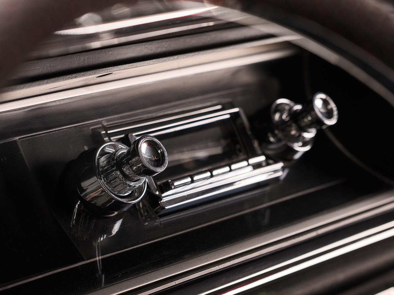 012 1965 Chevrolet Impala SS retro style radio close up with chrome detailing preserving vintage dashboard aesthetics