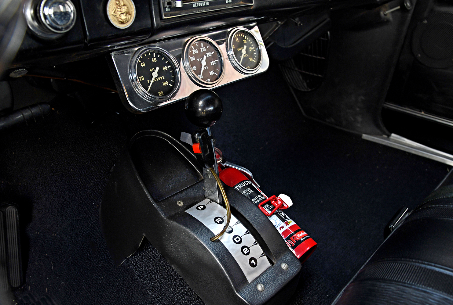 012 1967 Chevrolet Nova SS interior showing center console additional gauges and a mounted fire extinguisher