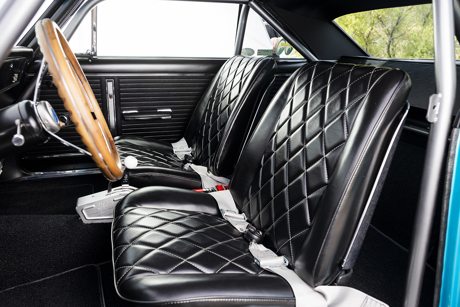 012 Black diamond stitched interior seats in a 1966 Chevy Nova with classic wood steering wheel and performance shifter