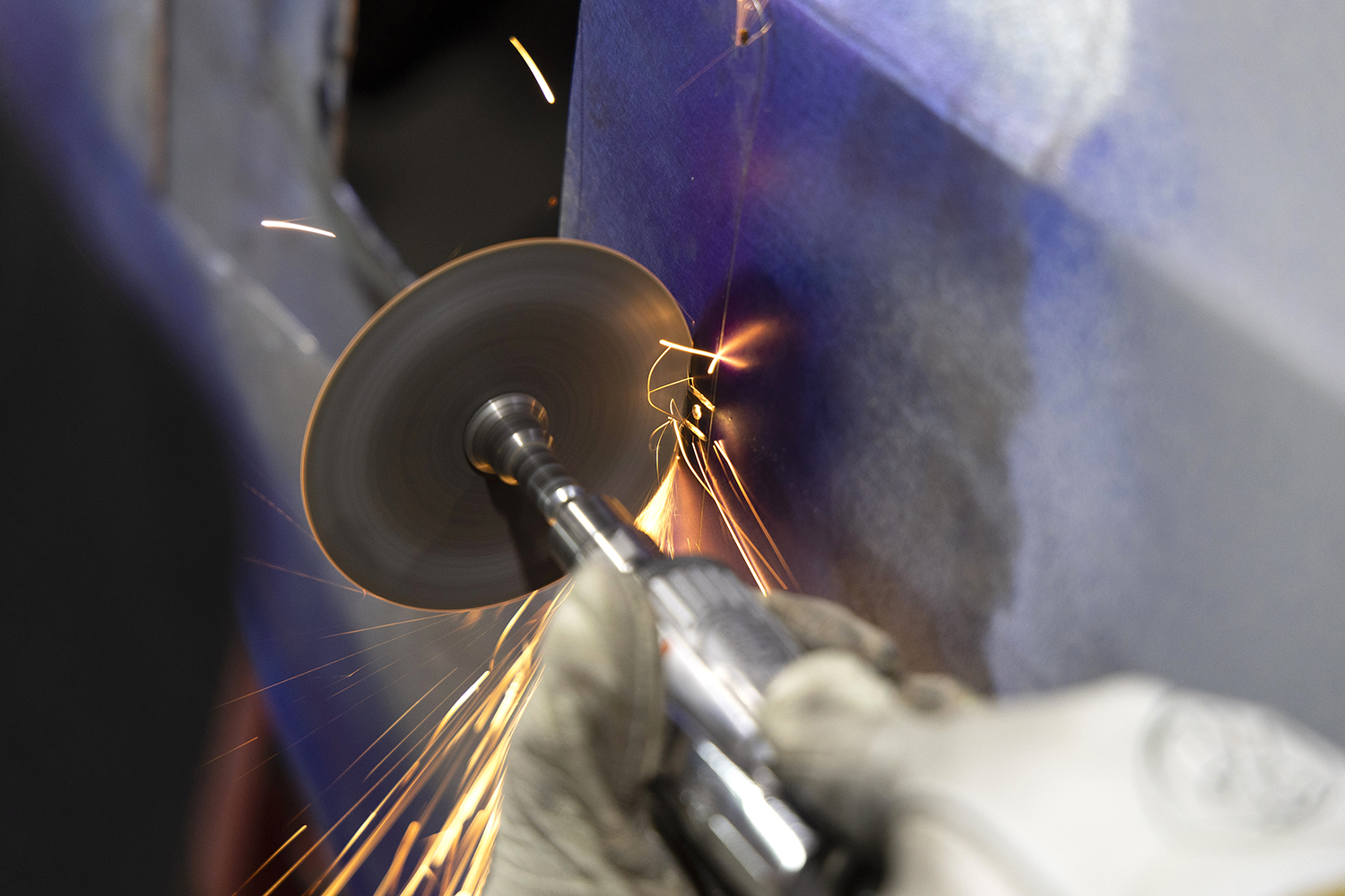 012 High speed cutting wheel sparks as excess metal is trimmed from the patch panel for a seamless fit