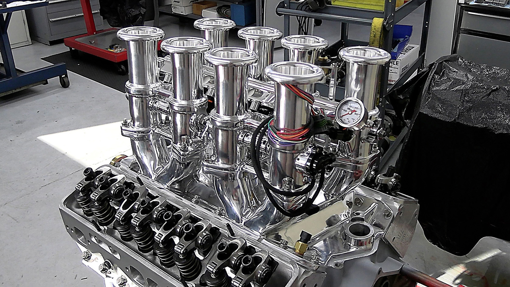 012 Polished individual throttle bodies on the Chevy 424 engine with visible fuel pressure gauge and wiring
