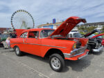 013 1956 Chevrolet 210 gasser in bright orange with a straight axle and raised front end