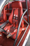 013 1961 Chevrolet Impala race seat with red upholstery five point harness and reinforced roll cage for drag racing security