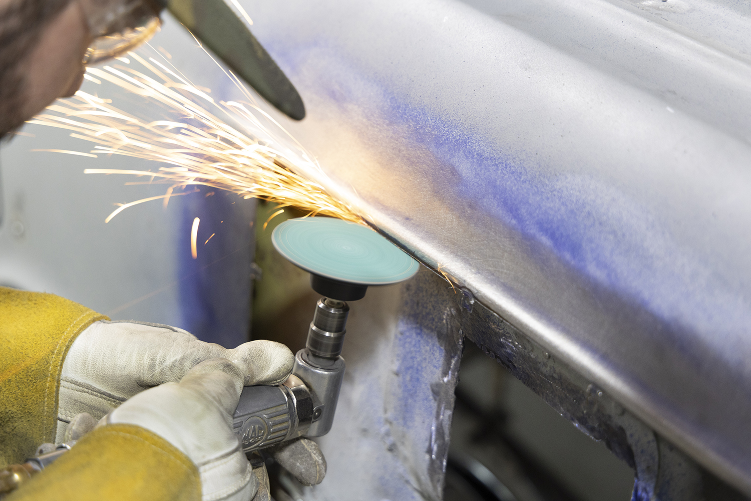 014 Grinding disc smooths the edges of the quarter panel ensuring a flush transition for the welded patch