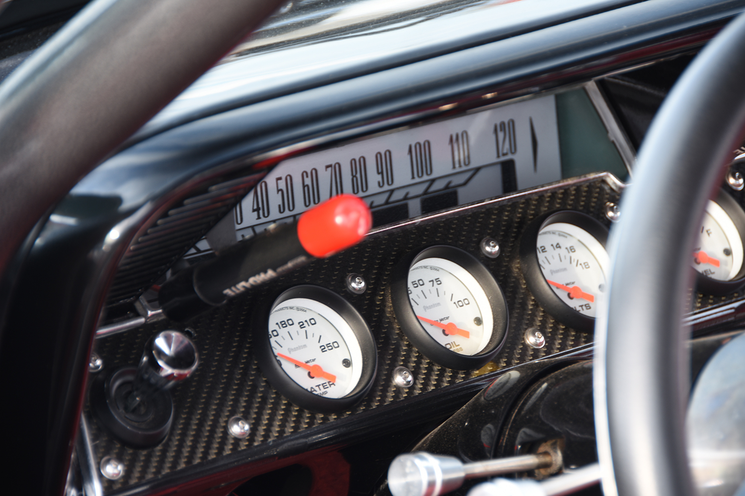 015 1961 Chevrolet Impala race gauges with carbon fiber panel AutoMeter dials and factory speedometer for performance monitoring
