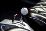 015 B&M shifter with white shift knob installed in a 1966 Chevy Nova for enhanced drag racing control