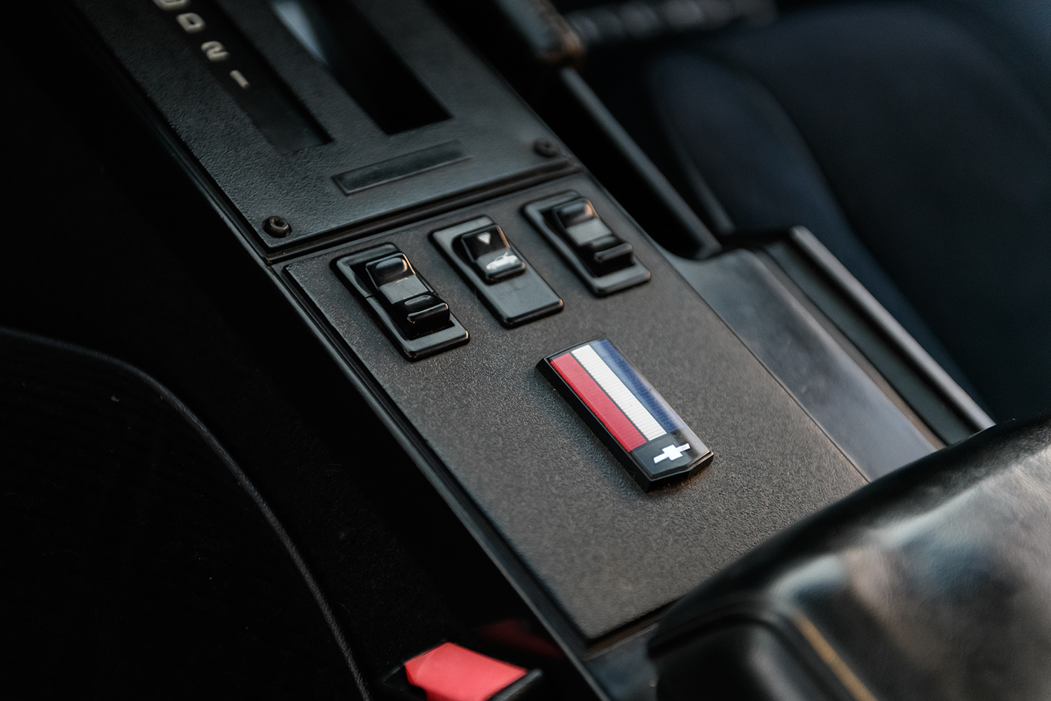 016 1986 Camaro IROC Z center console with classic power window controls and tri color Chevy emblem