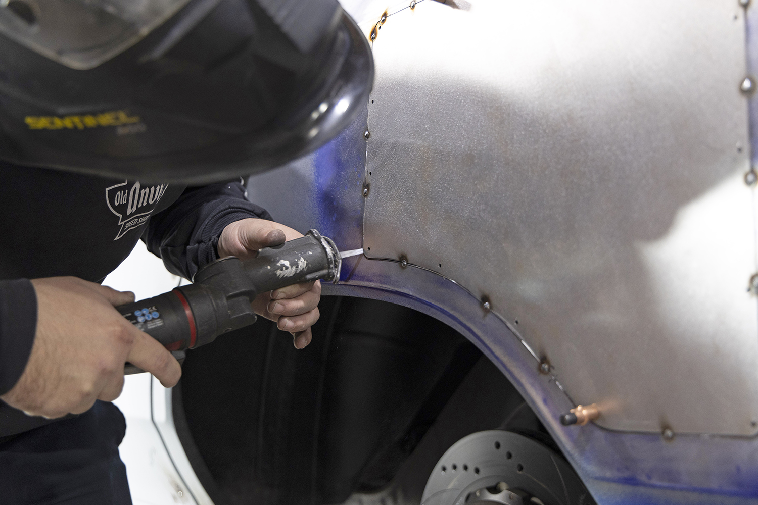 019 Fabricator uses a pneumatic punch to prepare the panel for final welding and seamless blending