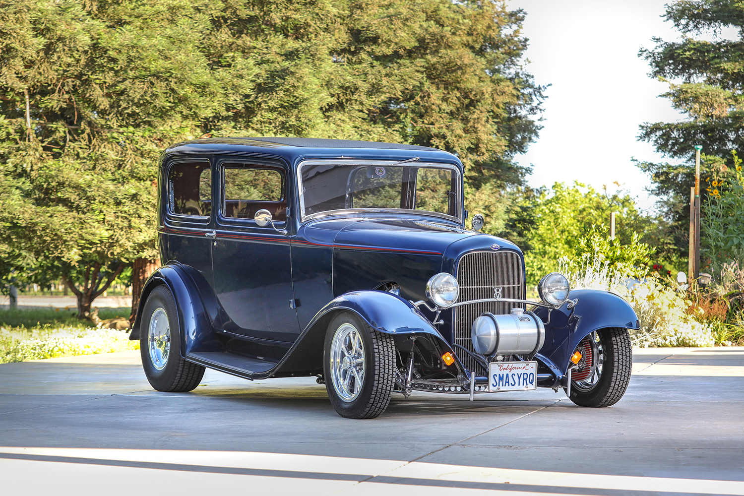 02 1932 Ford Tudor front three quarter view highlighting the grille headlights and exposed suspension