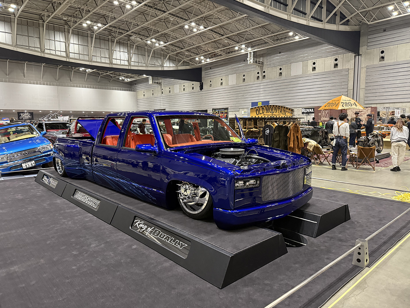 02 1990s Chevy Dually – Deep blue bagged with billet wheels and a custom grille sitting low