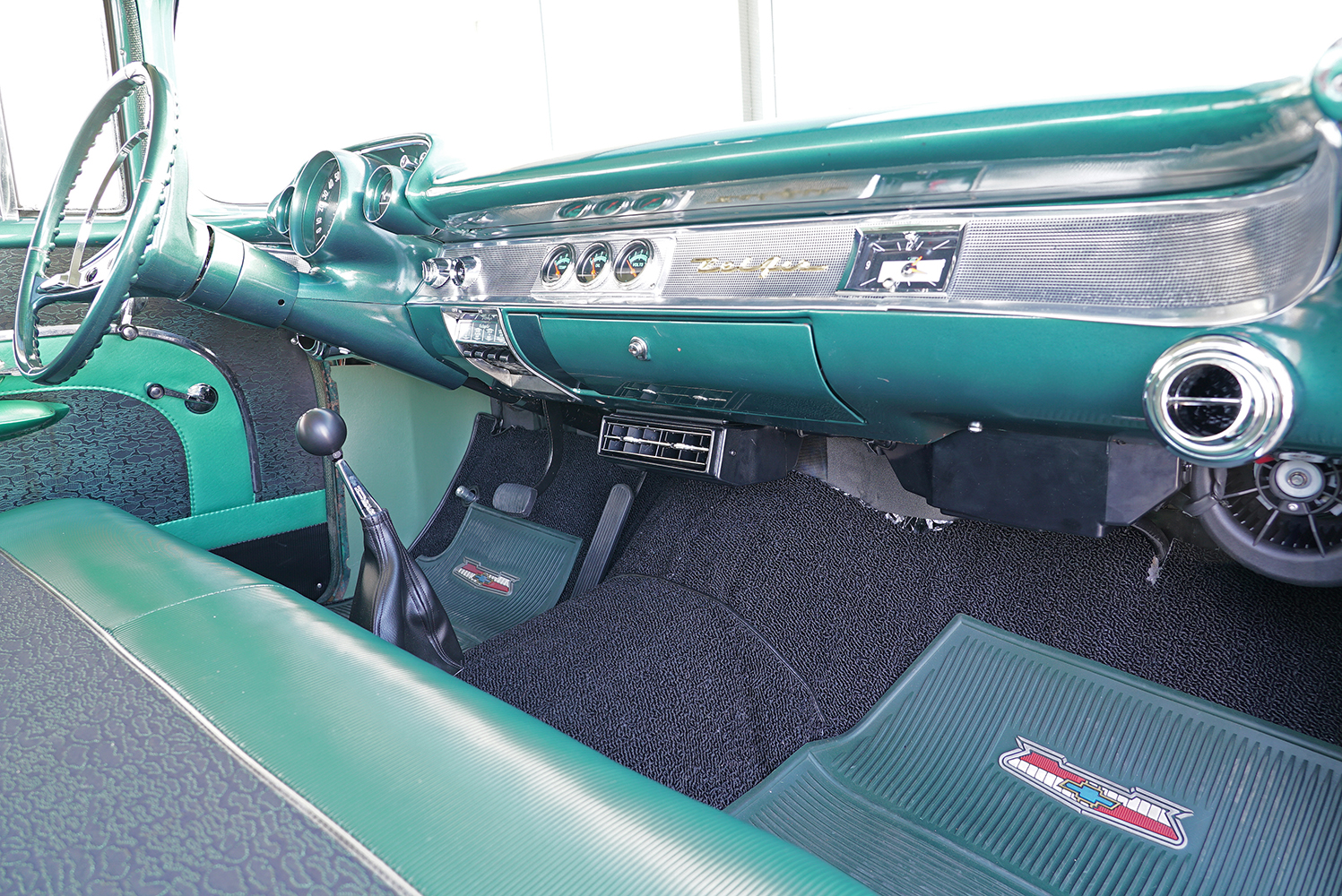 02 Interior of a 1957 Chevrolet Bel Air featuring a green dashboard with a Vintage Air under dash AC unit installed