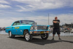 021 1966 Chevy Nova Gasser in turquoise Earthquake II livery with raised front suspension and polished velocity stacks at marina