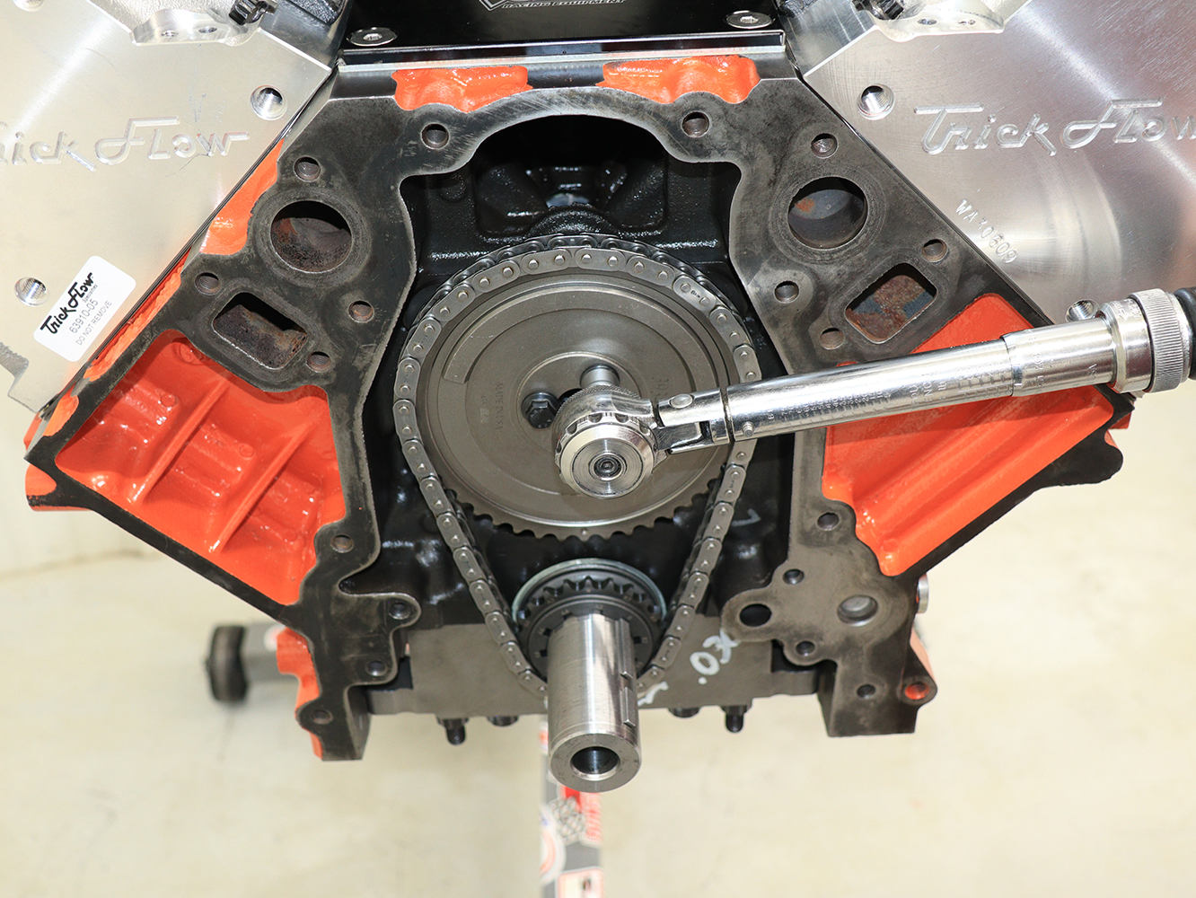 029 LS3 engine assembly torqueing camshaft sprocket with Trick Flow cylinder heads visible in the background