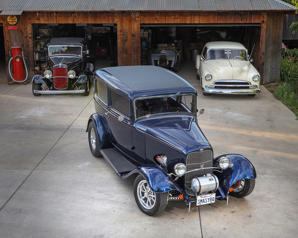 03 1932 Ford Tudor overhead shot parked in front of a vintage garage