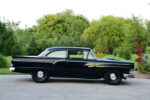 03 1957 Ford Custom Sedan with glossy black paint chrome trim and a sleek stance on steel wheels