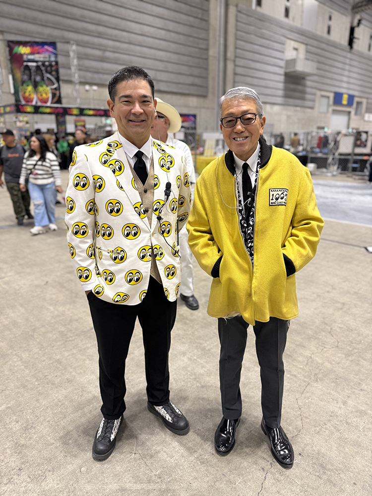 03 Two men in Mooneyes attire – One in a smiley face blazer the other in a yellow Mooneyes jacket