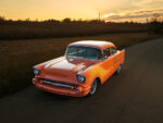04 1957 Chevrolet Bel Air with a stunning sunset reflection on its flawless paint and custom wheels