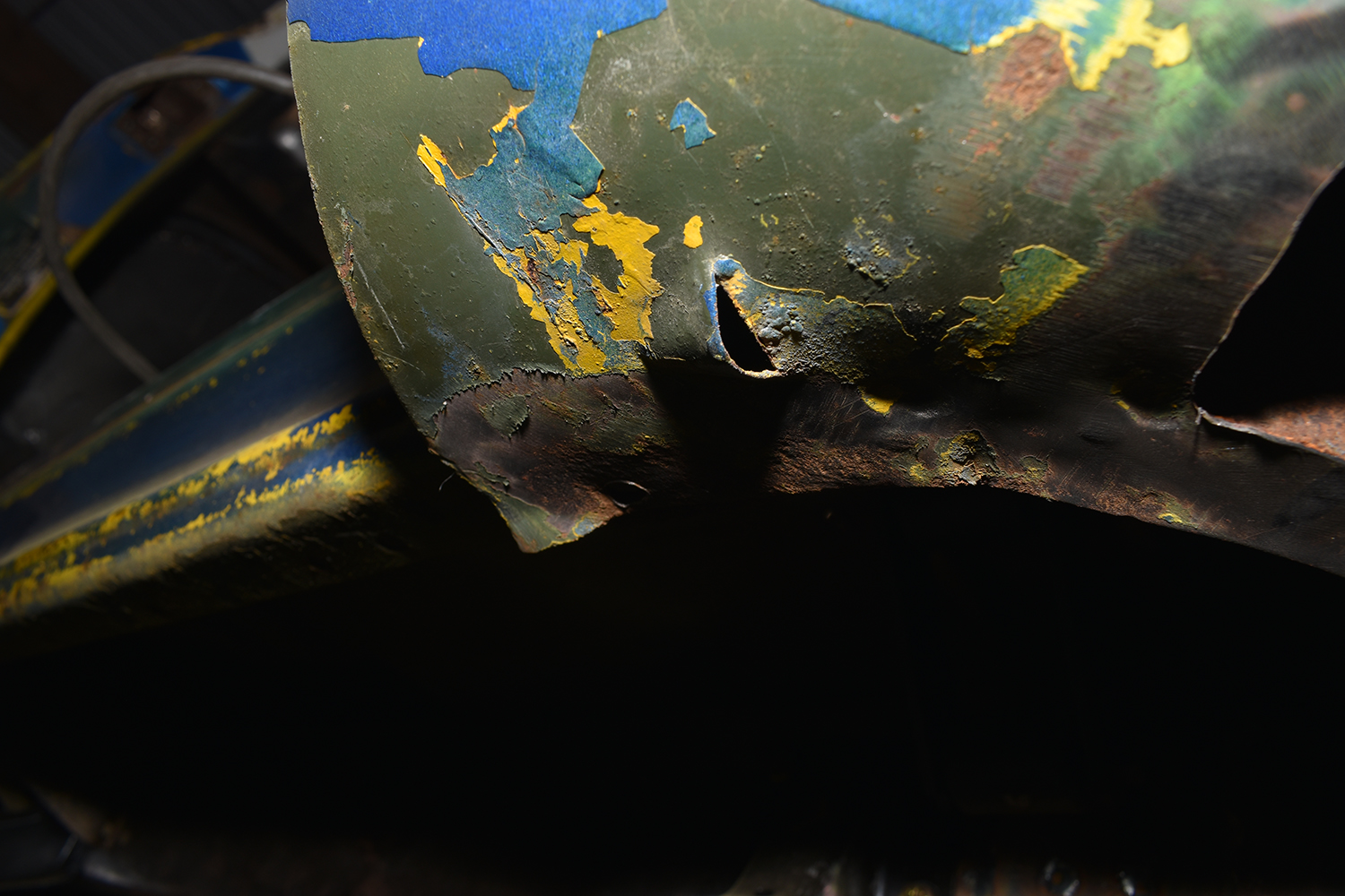 04 Rust holes and peeling paint exposing underlying metal damage