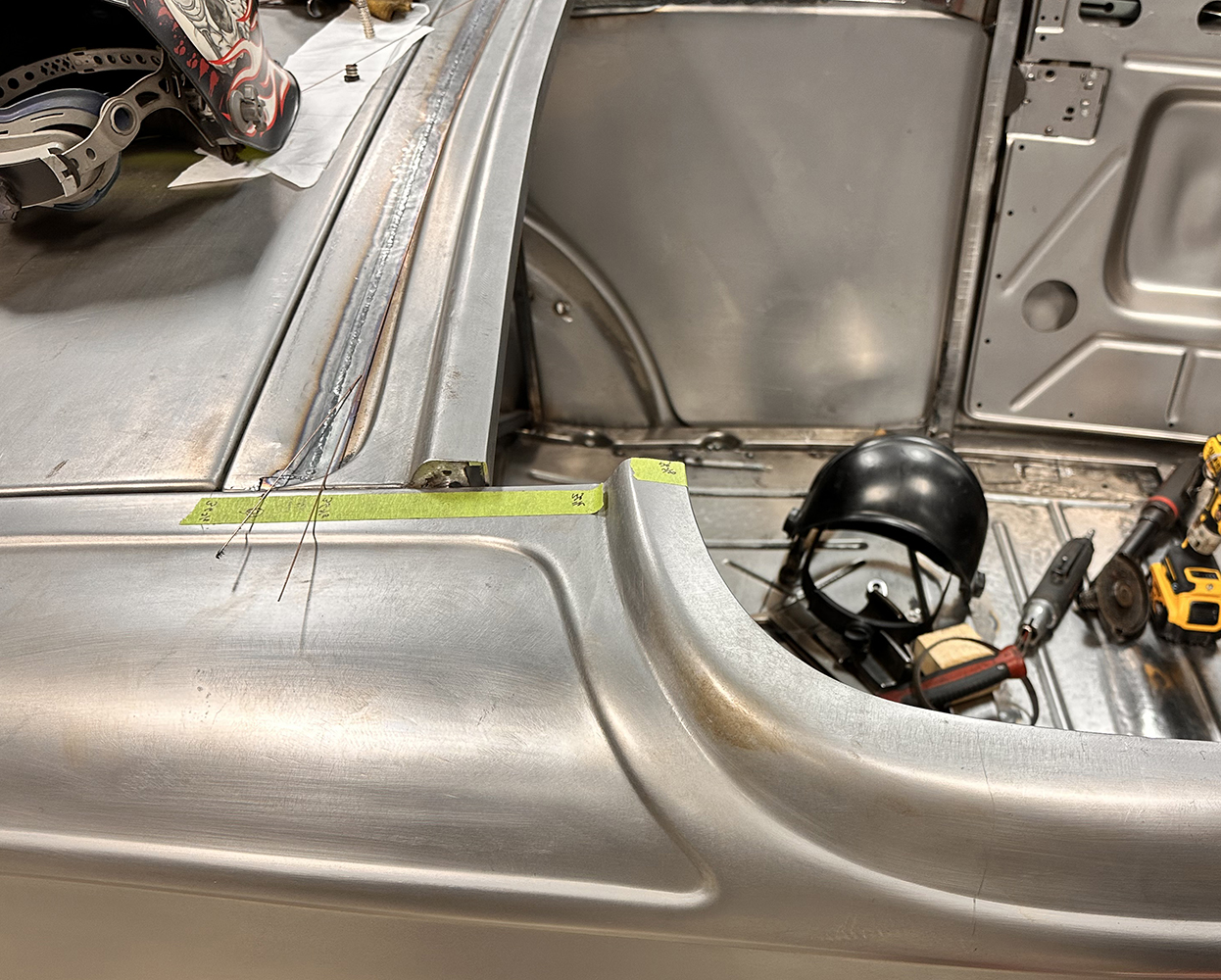 04 The rear deck of a 1932 Ford Roadster under construction with welding work on the body seam
