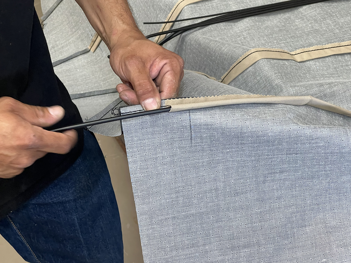 04 Worker inserting support rods into the headliner fabric for a 1970 Chevy Nova