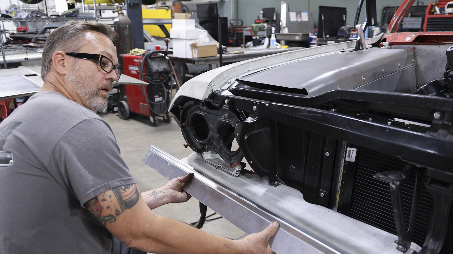 05 Test fitting a newly shaped aluminum panel on the front end of a 1962 Chevy Impala