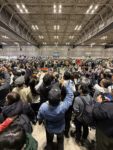 06 Huge crowd at the show – Attendees gathered taking photos of a special reveal moment