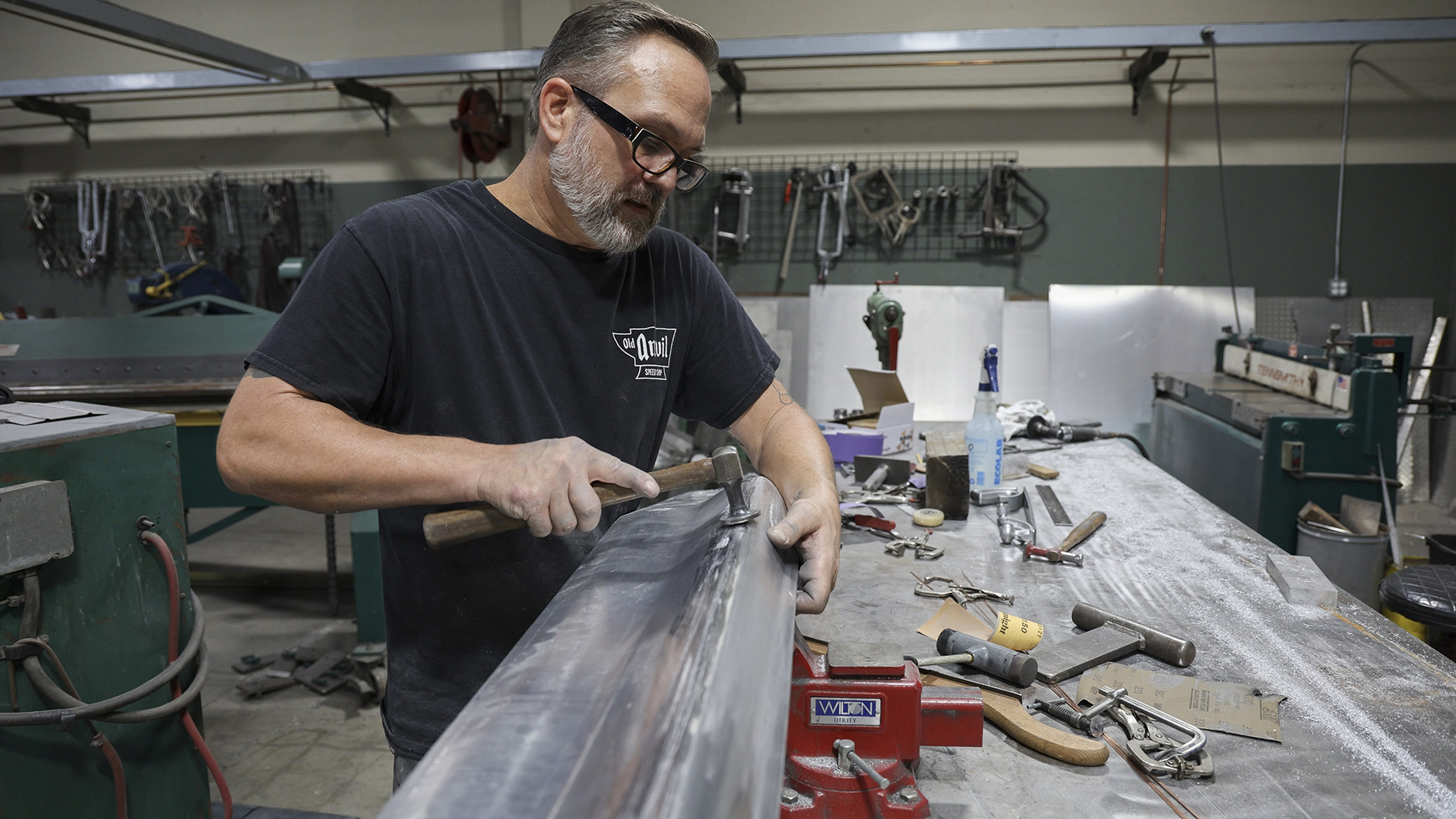 07 A metal fabricator hammering a custom aluminum panel for the 1962 Chevy Impala