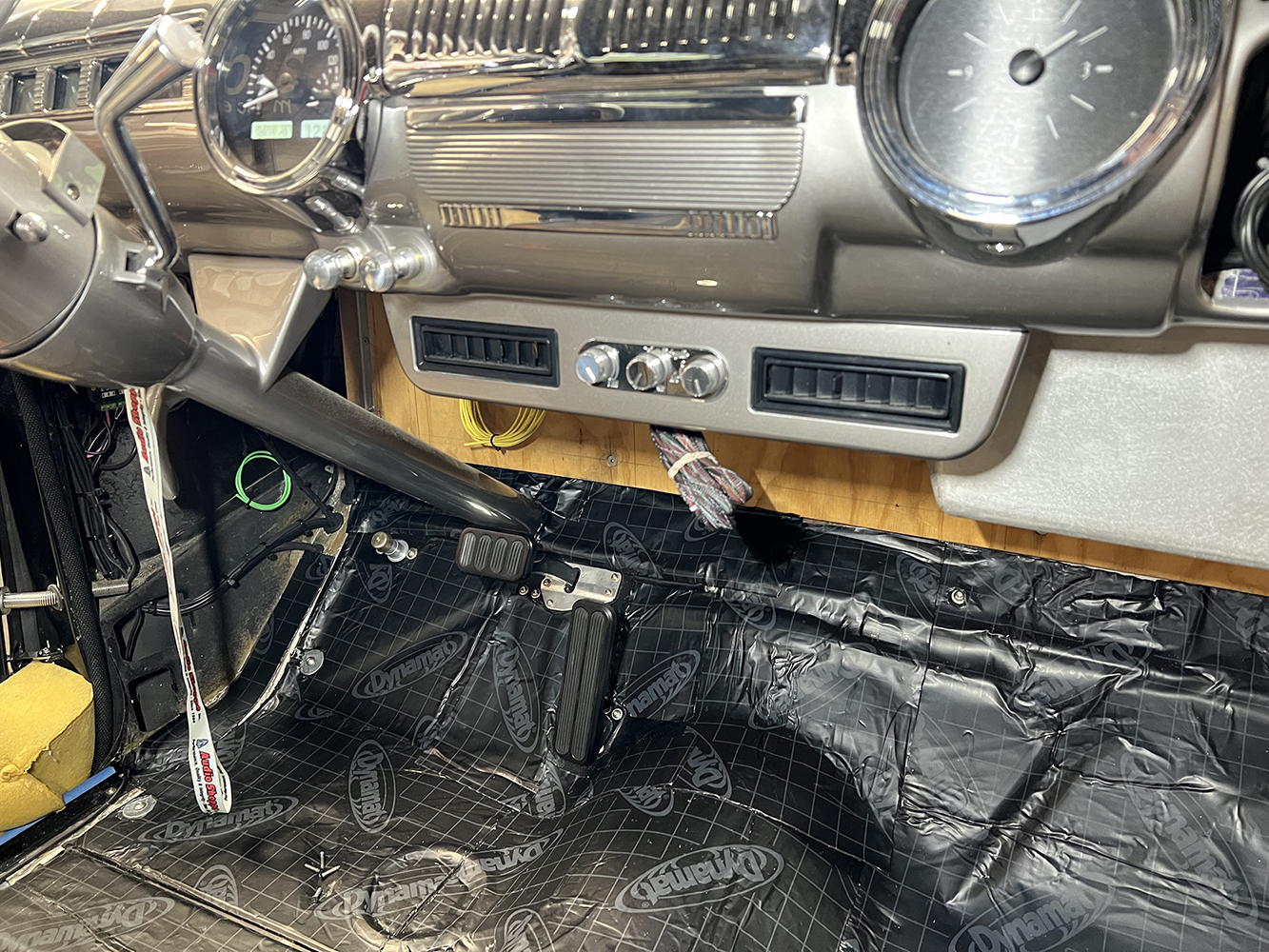 07 Under dash Vintage Air AC vents installed in a classic car interior with chrome dash trim and a black Dynamat lined floor