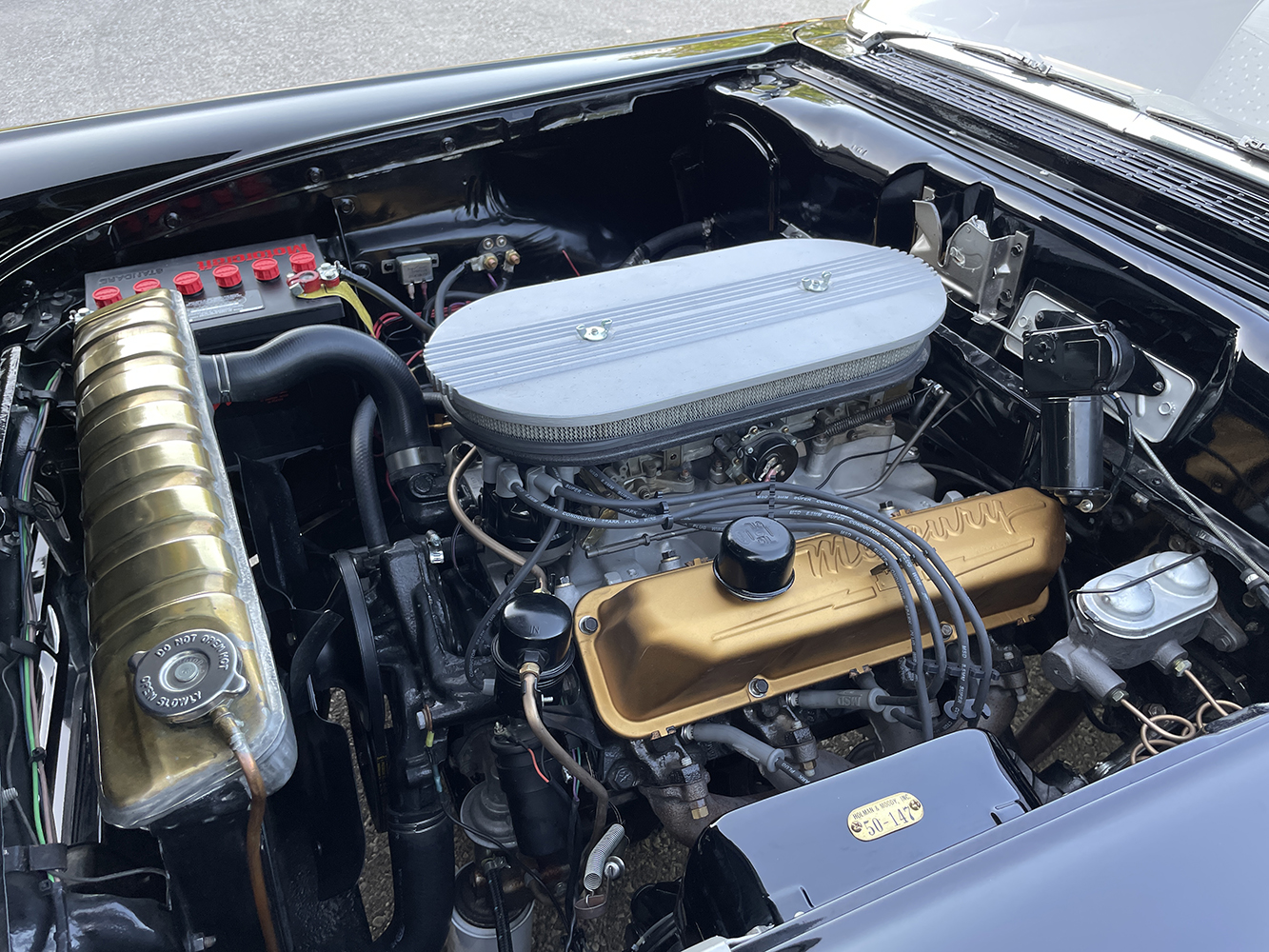 09 1957 Ford Custom engine bay with a Mercury valve covered V8 finned air cleaner and vintage performance parts