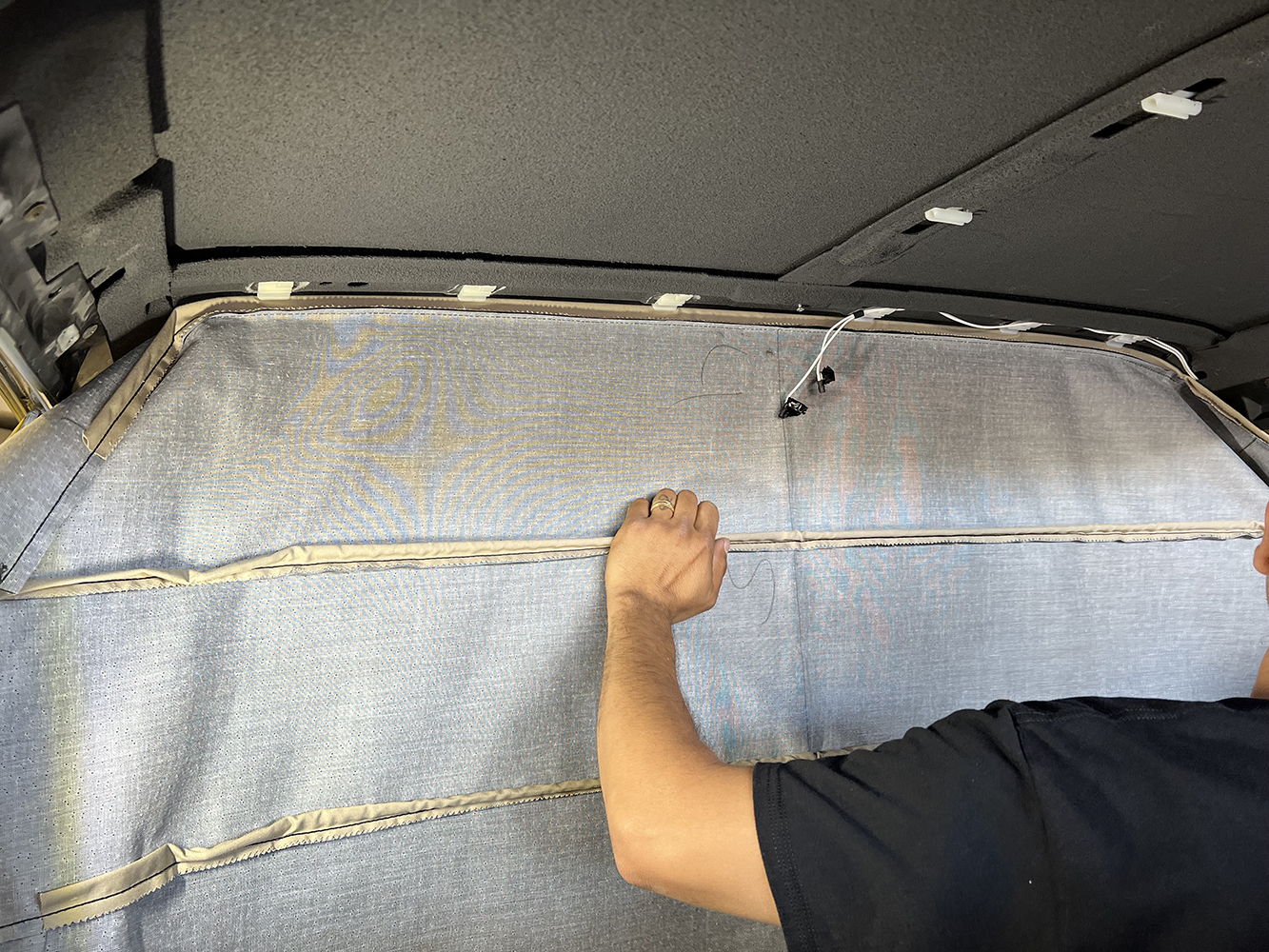 09 Final adjustments and smoothing of the headliner fabric in a 1970 Chevy Nova