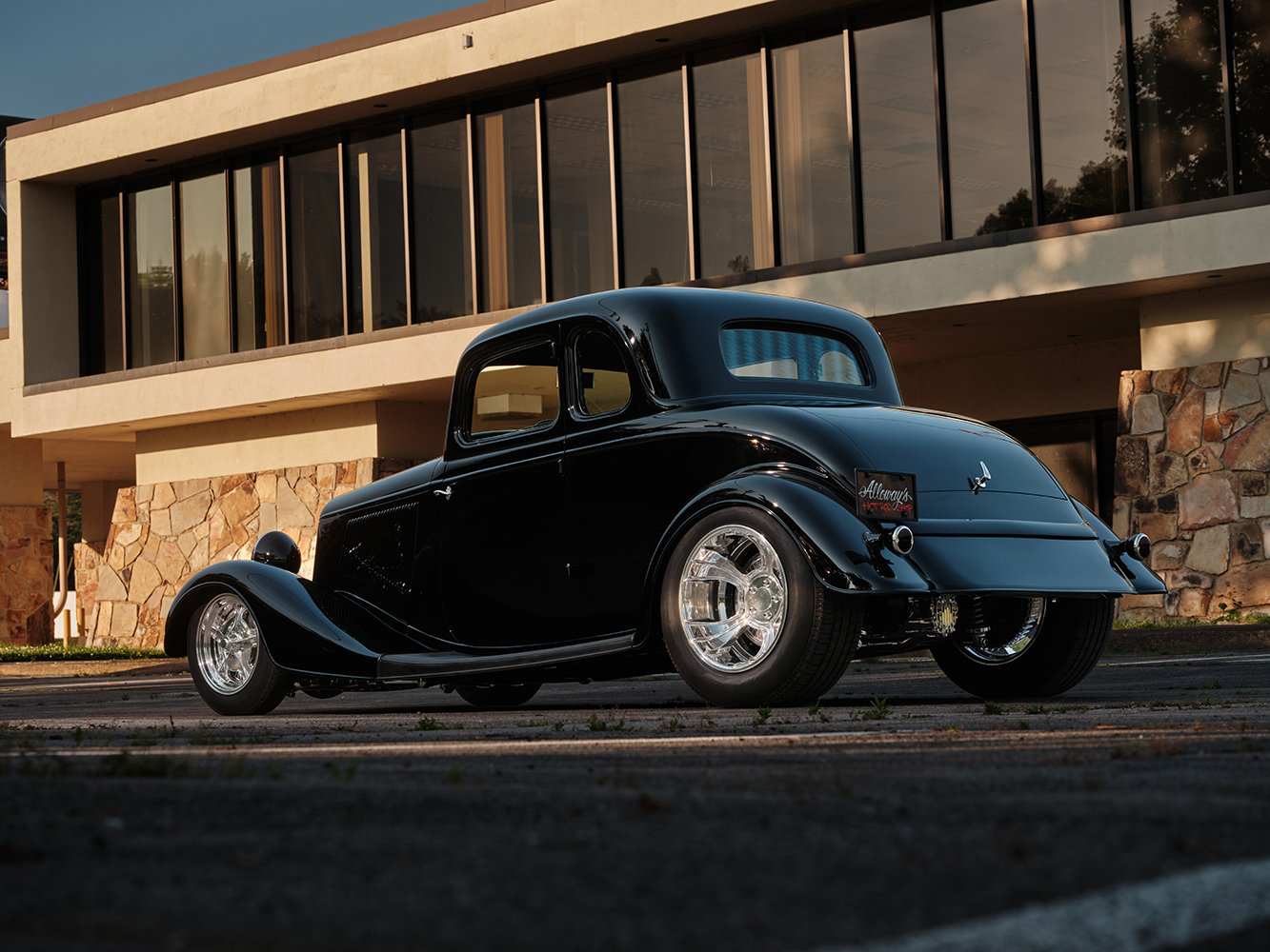 10 1933 Ford Five Window Coupe rear three quarter view featuring a smooth trunk and chrome exhaust tips