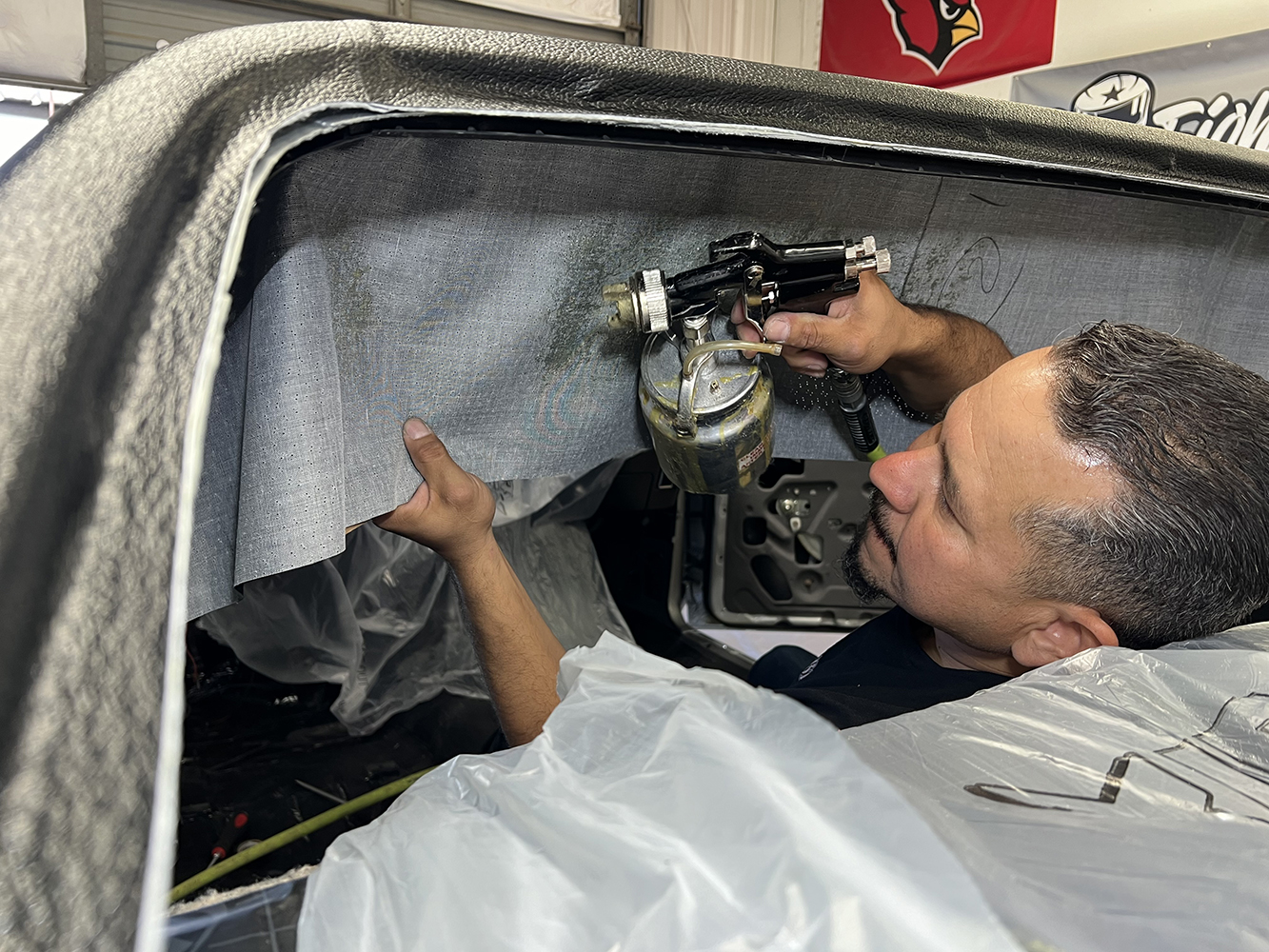 10 Applying adhesive and securing the edges of the 1970 Chevy Nova headliner for a clean finish