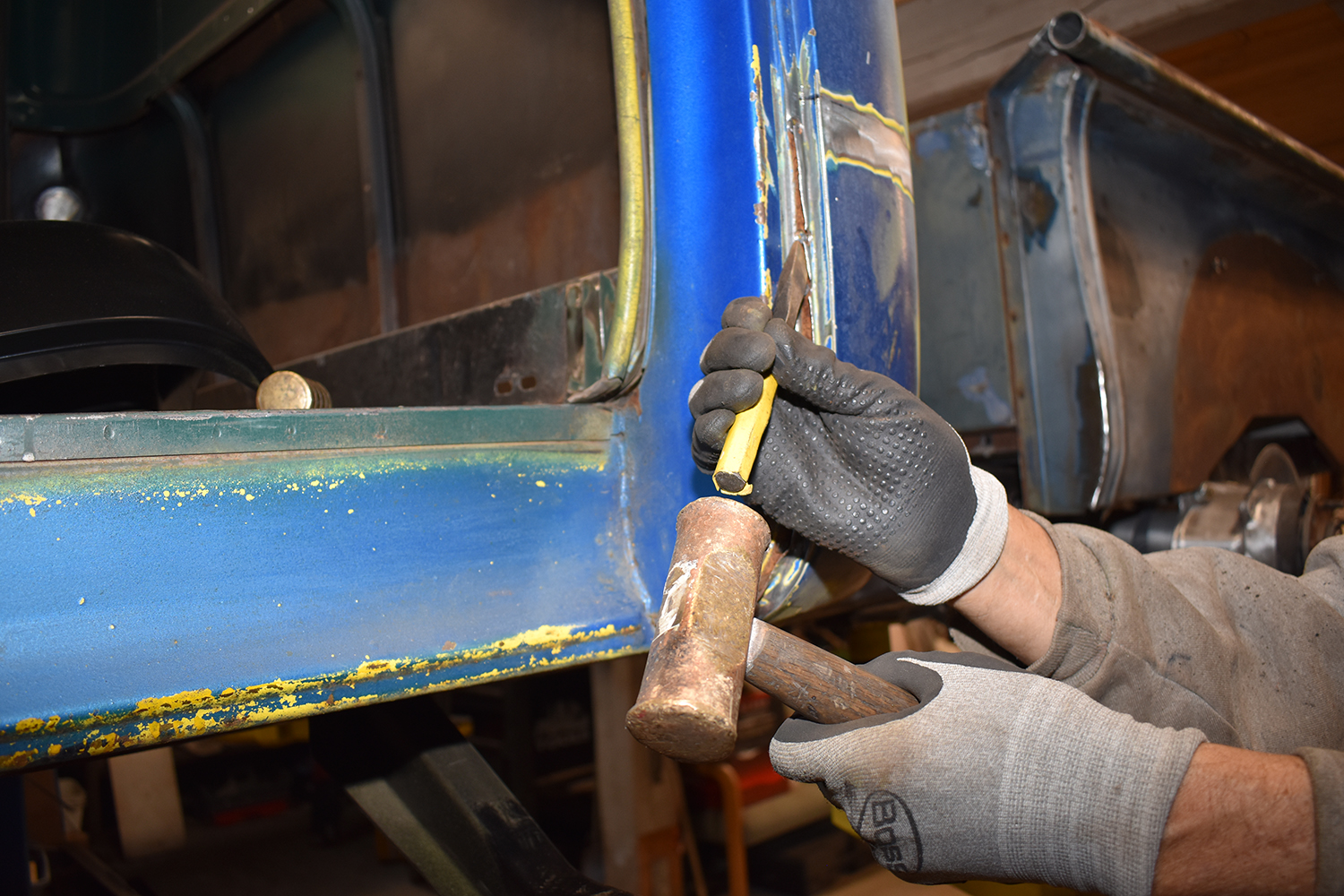 11 Chiseling away rusted metal from the truck’s door frame for panel replacement