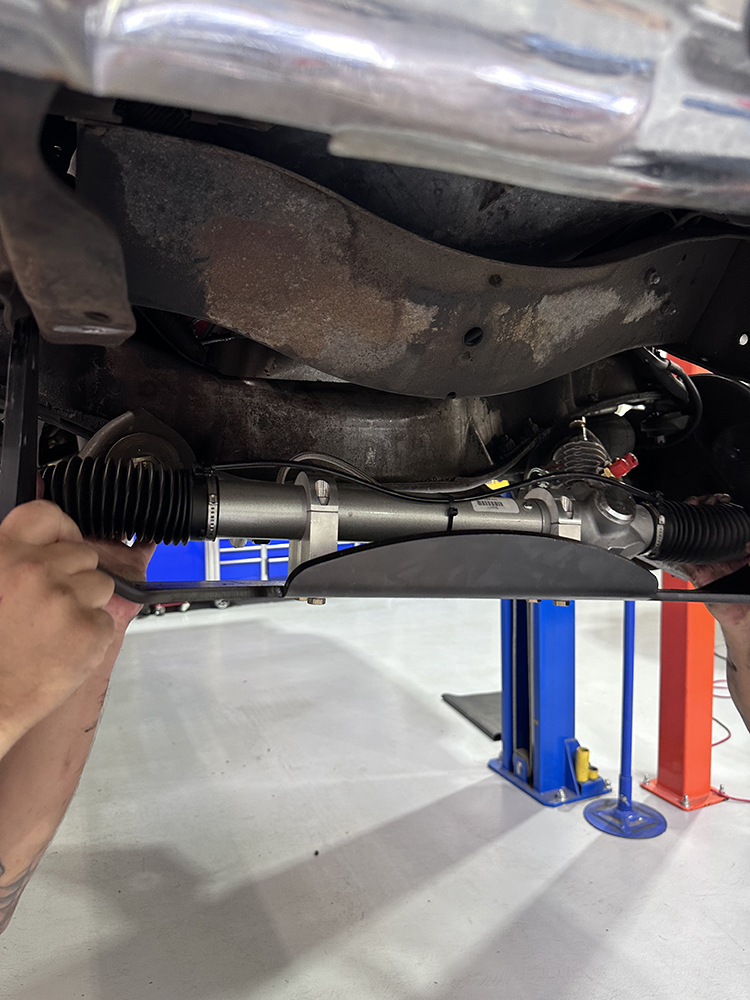 11 Positioning the rack and pinion unit onto the frame for final installation