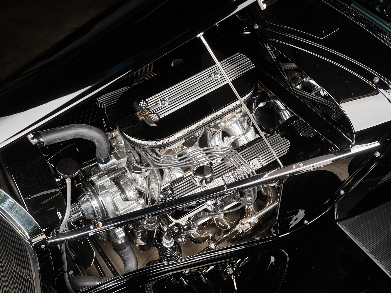 12 1933 Ford Five Window Coupe engine bay featuring a high performance Cobra powered V8 with polished valve covers