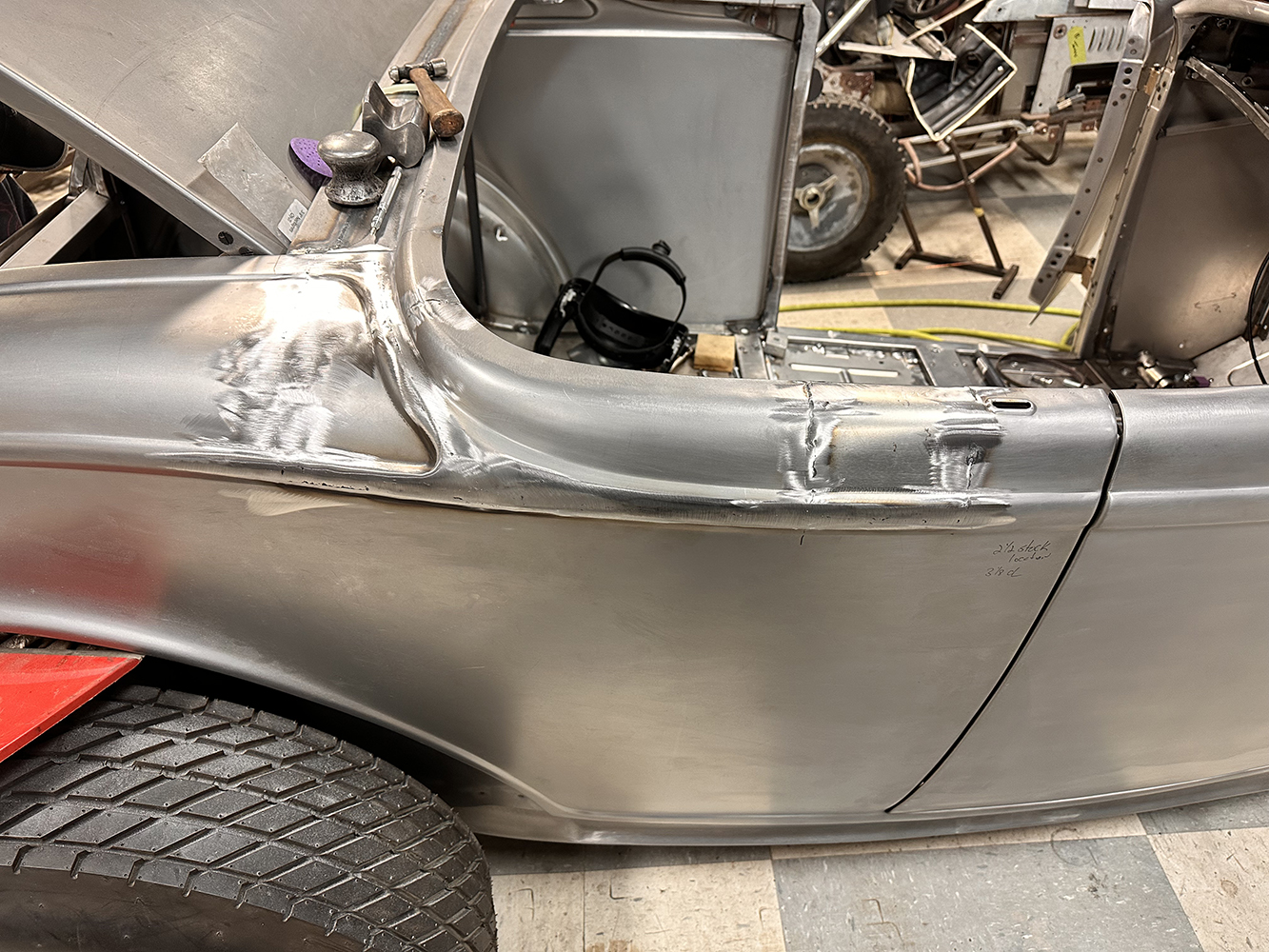 12 Smoothed and blended metalwork on the quarter panel of a 1932 Ford Roadster after welding and grinding