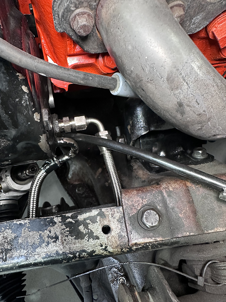12 Stainless steel braided power steering lines routed to the steering box and frame