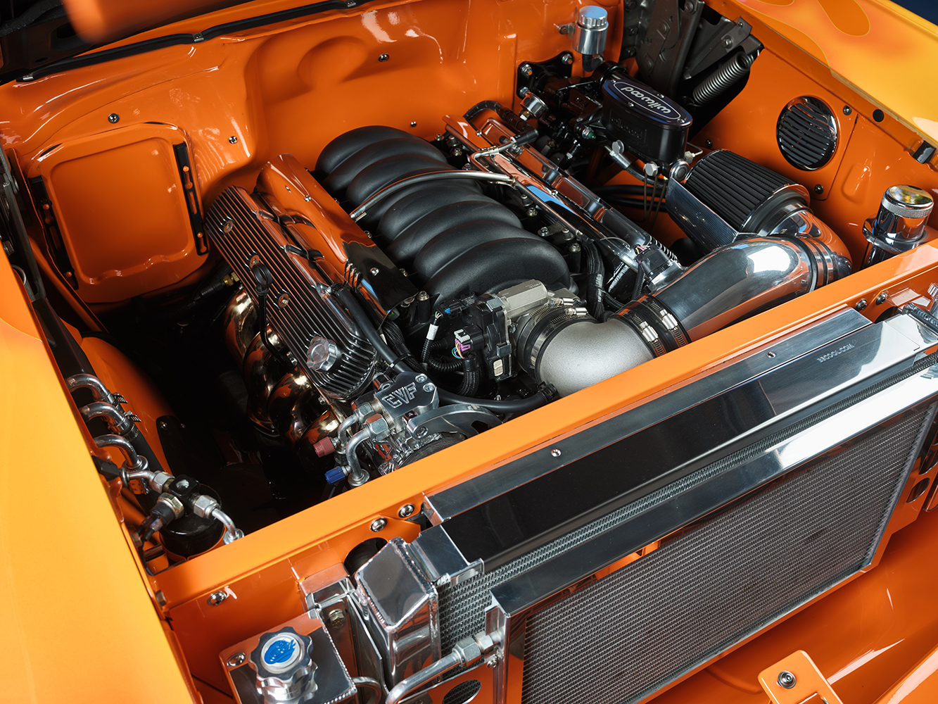 13 1957 Chevrolet Bel Air engine bay featuring an LS powerplant with polished components and a custom intake system