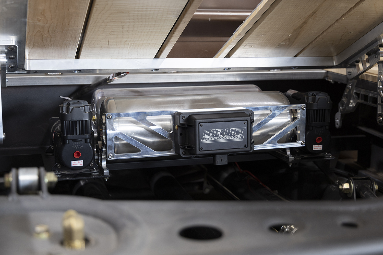 13 Fully installed Air Lift Performance system under a slatted wood truck bed