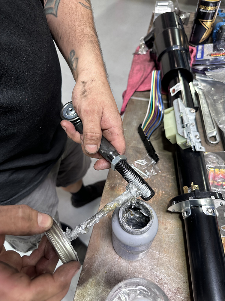 15 Applying anti seize lubricant to the new tie rod ends before installation