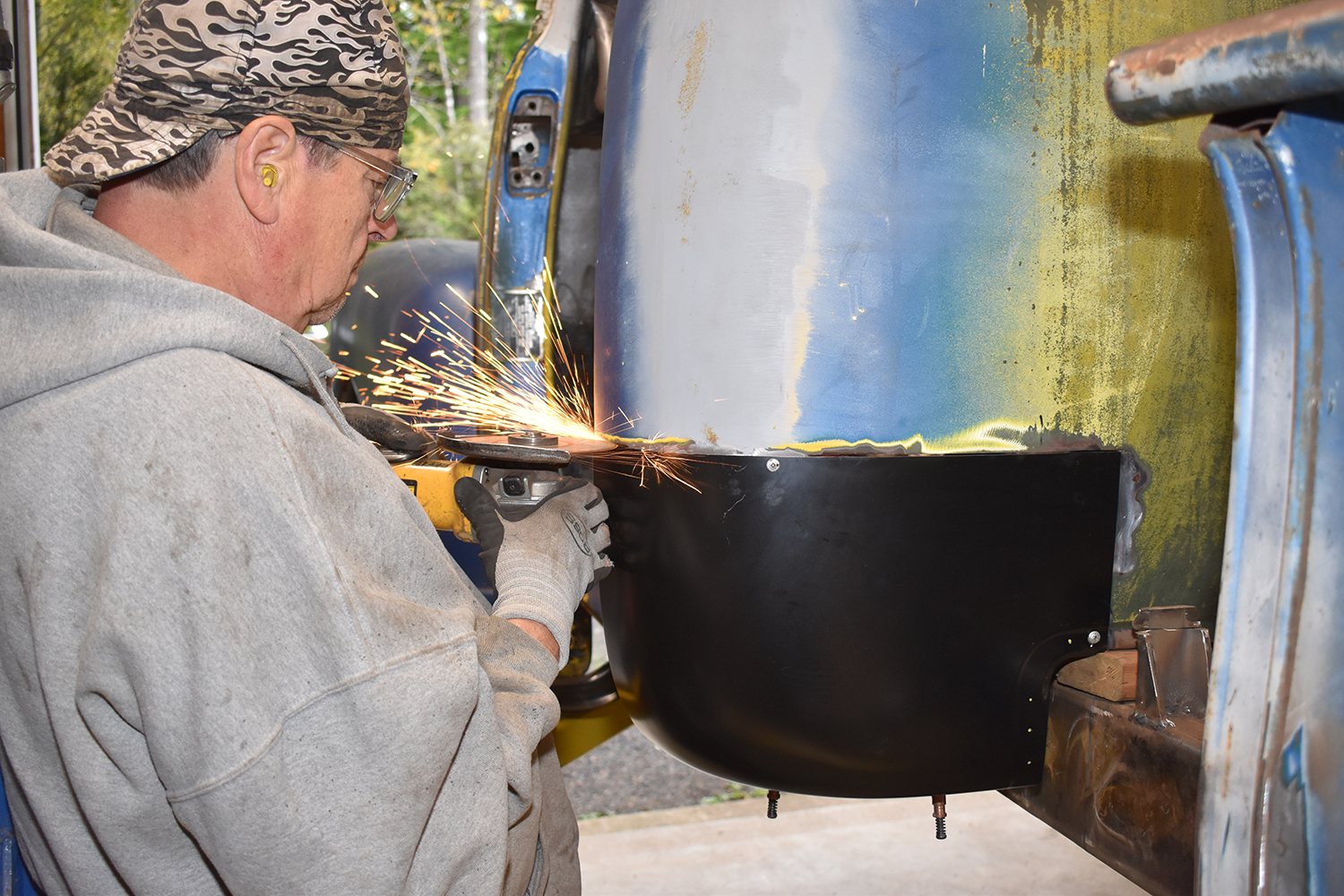 15 Grinding down welds to create a seamless finish on the new panel