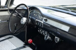 16 1957 Ford Custom dashboard featuring a black finish chrome accents and auxiliary gauges