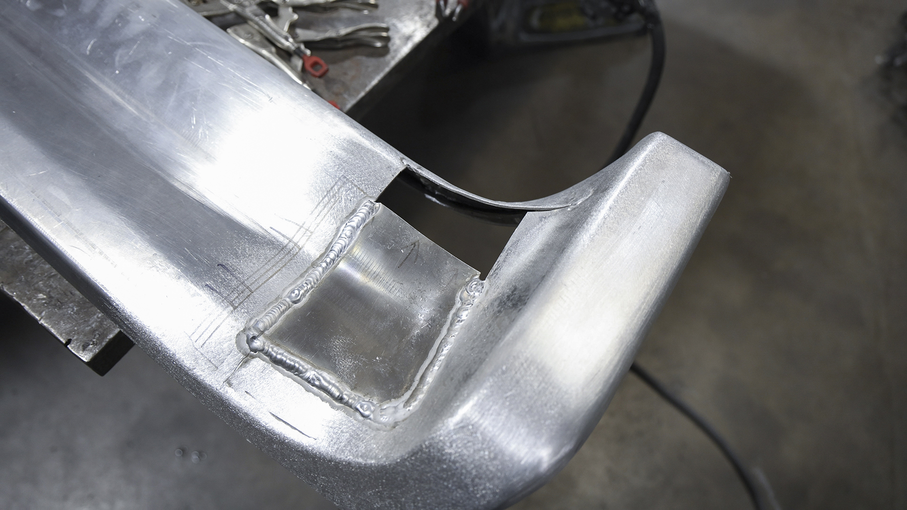 16 A custom fabricated rear bumper section for a 1962 Chevy Impala with intricate TIG welds