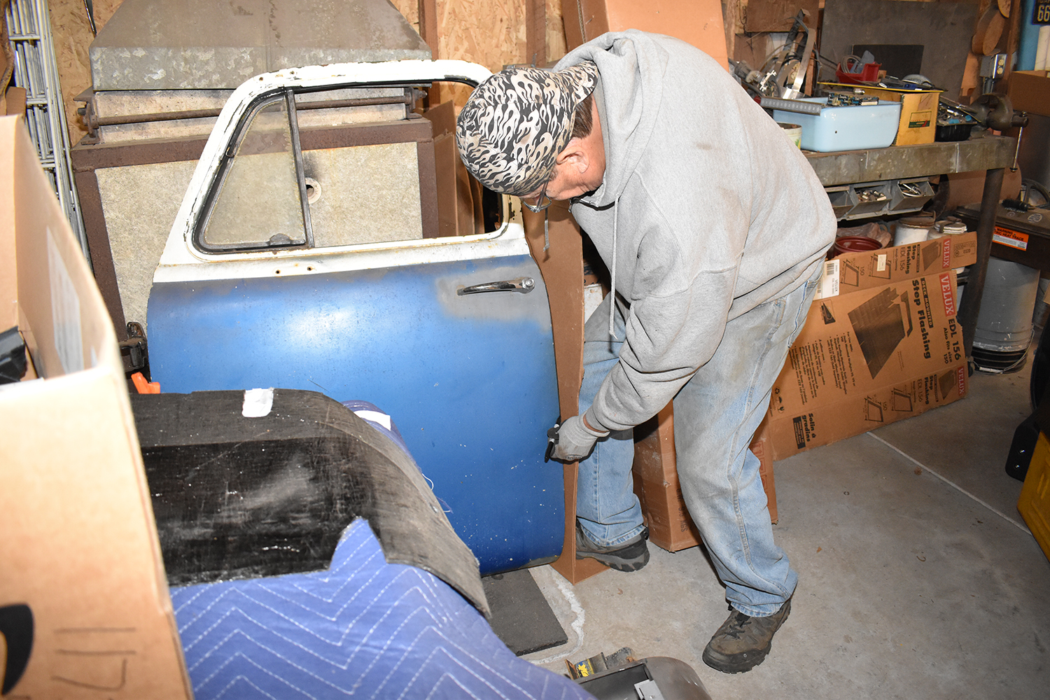 18 Tracing a cardboard template against a truck door for a custom repair panel